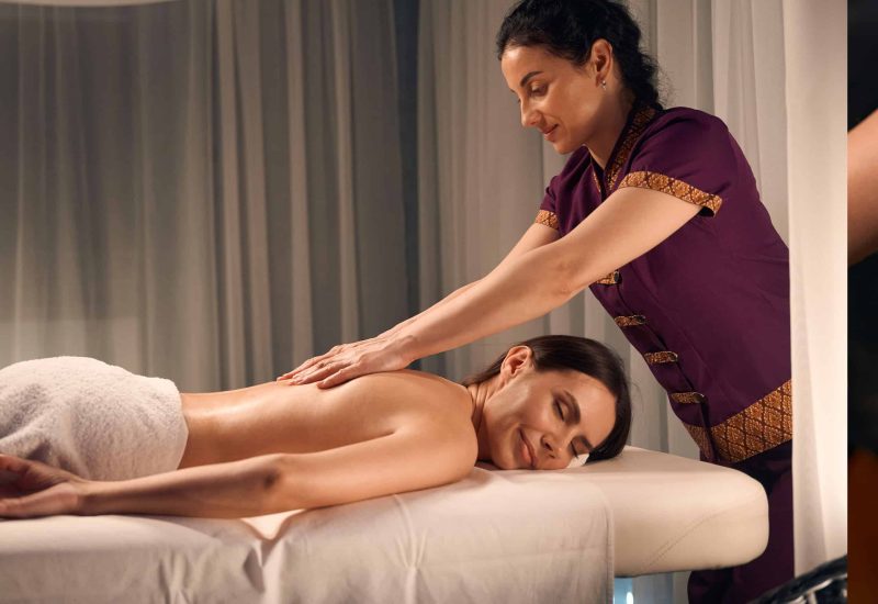 wellness-center-masseuse-giving-relaxing-back-mass-